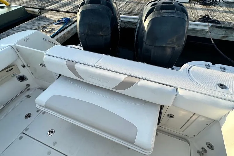 Slide: The Image of 2009 Boston Whaler 285 Conquest boat interior with dual engines and seating. - 17