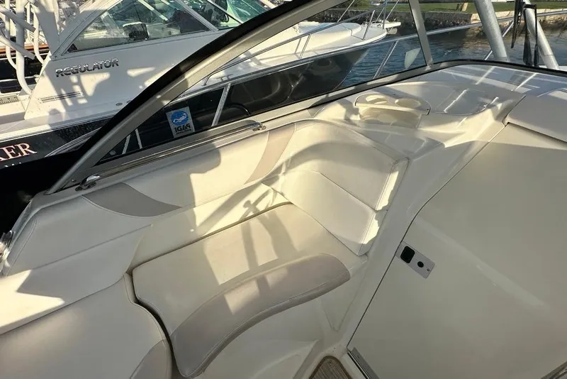 Slide: The Image of 2009 Boston Whaler 285 Conquest boat interior with cushioned seating and cup holders. - 3