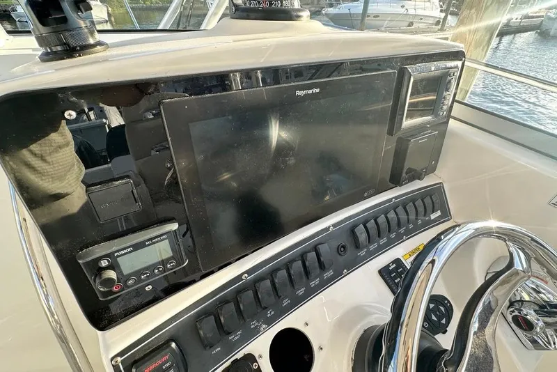 Slide: The Image of 2009 Boston Whaler 285 Conquest dashboard with navigation controls and steering wheel. - 4