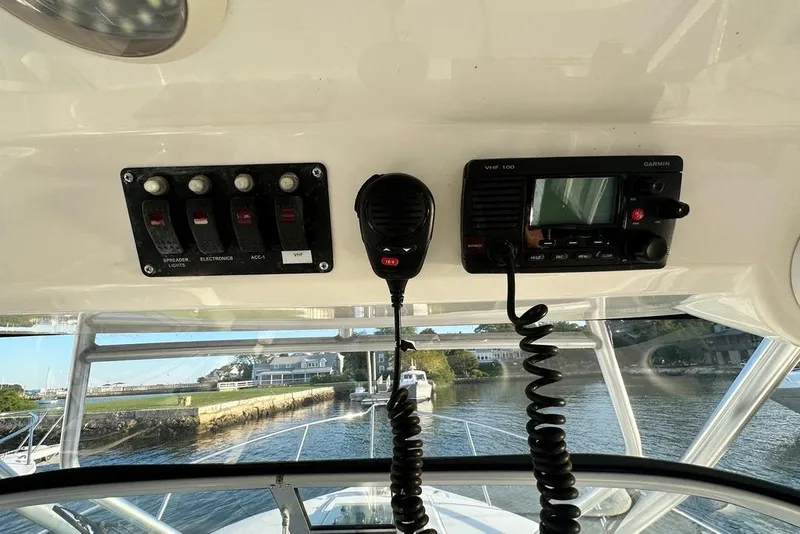 Slide: The Image of 2009 Boston Whaler 285 Conquest dashboard with VHF radio and control panel. - 6