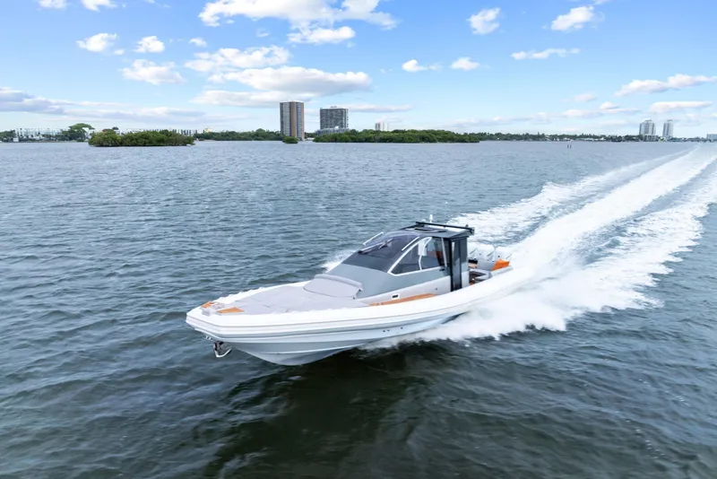 Slide: The Image of 2021 Magazzu TARGA 45 speedboat cruising on open water under a clear sky. - 10