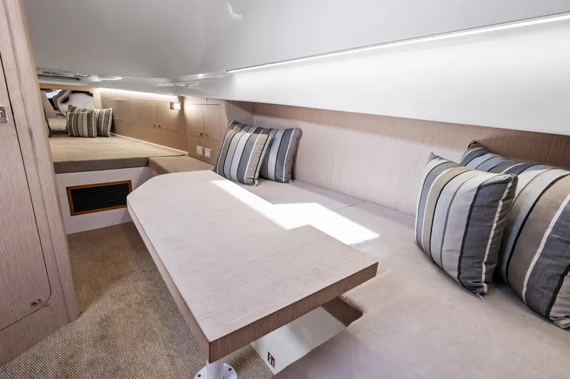 Slide: The Image of Interior of 2021 Magazzu TARGA 45 yacht with cozy seating and striped cushions. - 15