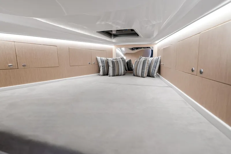 Slide: The Image of Luxurious interior cabin of 2021 Magazzu TARGA 45 with striped pillows and sleek wood paneling. - 16