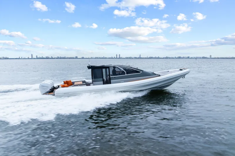 Slide: The Image of 2021 Magazzu TARGA 45 boat cruising on open water under a blue sky. - 2