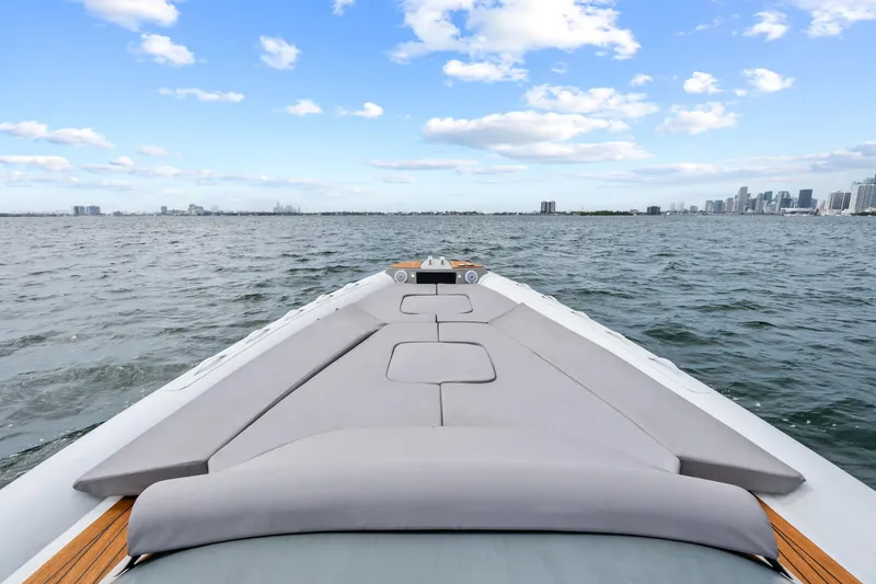 Slide: The Image of Magazzu TARGA 45 yacht cruising on open water, city skyline in background, 2021 model. - 22