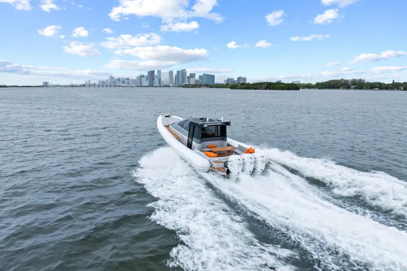 Slide: The Image of Magazzu TARGA 45 boat cruising on water with city skyline in background, 2021 model. - 4