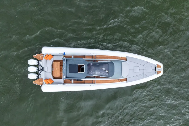 Slide: The Image of Aerial view of 2021 Magazzu TARGA 45 boat on water, showcasing sleek design and triple engines. - 5