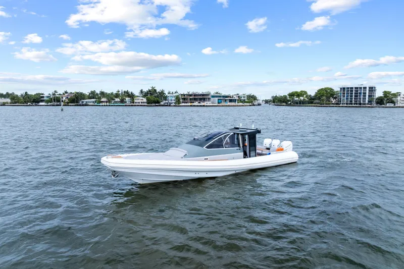 Slide: The Image of 2021 Magazzu TARGA 45 boat on calm water with scenic coastal backdrop. - 6