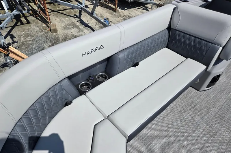 Slide: The Image of Luxurious seating on 2026 Harris Cruiser 230 boat with cup holders and quilted design. - 11
