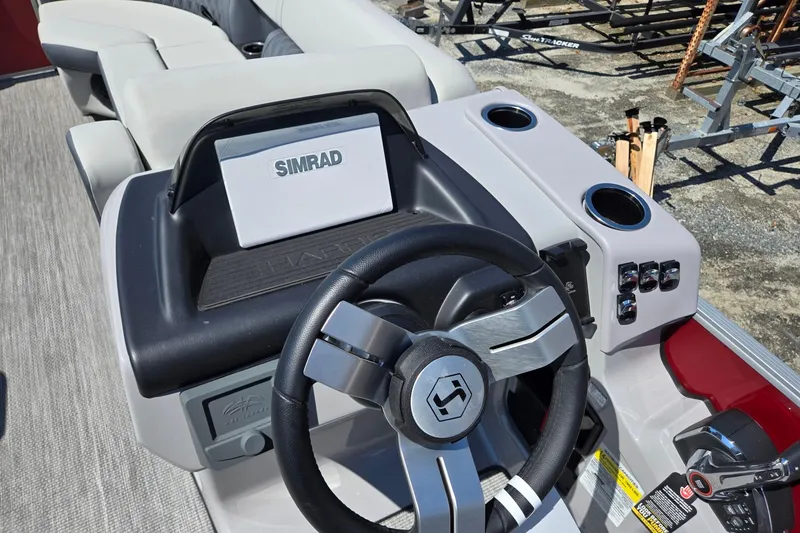 Slide: The Image of 2026 Harris Cruiser 230 dashboard with Simrad display and steering wheel. - 15