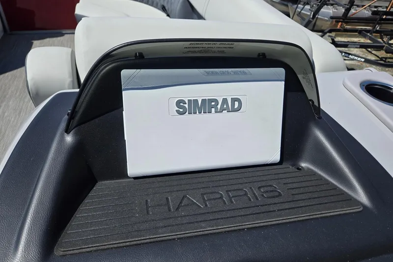 Slide: The Image of 2026 Harris Cruiser 230 dashboard featuring Simrad navigation system. - 16