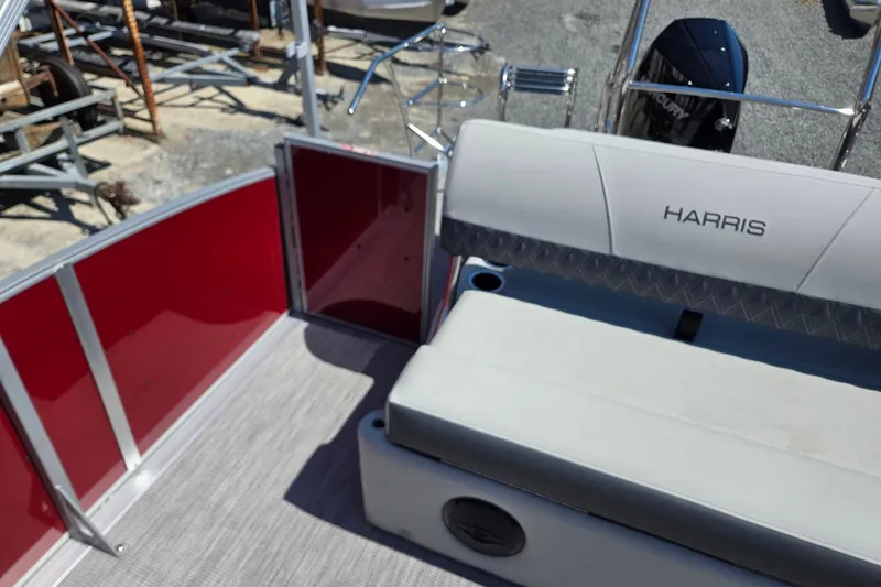 Slide: The Image of 2026 Harris Cruiser 230 pontoon boat interior with red paneling and cushioned seating. - 20