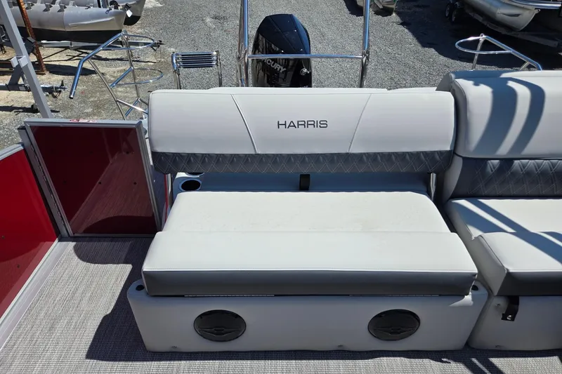 Slide: The Image of 2026 Harris Cruiser 230 boat interior with cushioned seating and storage compartments. - 21