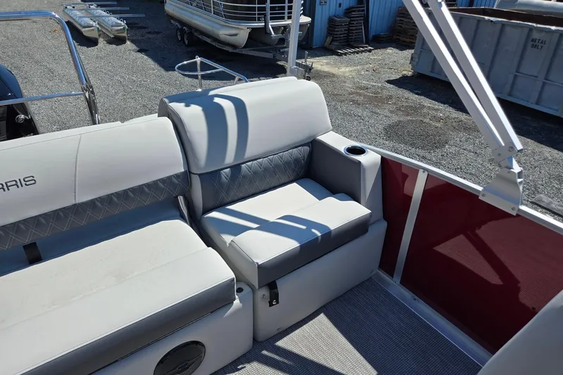 Slide: The Image of Interior seating of 2026 Harris Cruiser 230 pontoon boat, featuring plush upholstery and cup holder. - 22