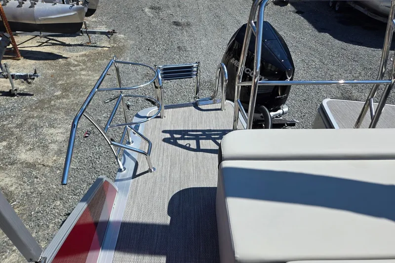 Slide: The Image of 2026 Harris Cruiser 230 boat deck with seating and outboard motor. - 23