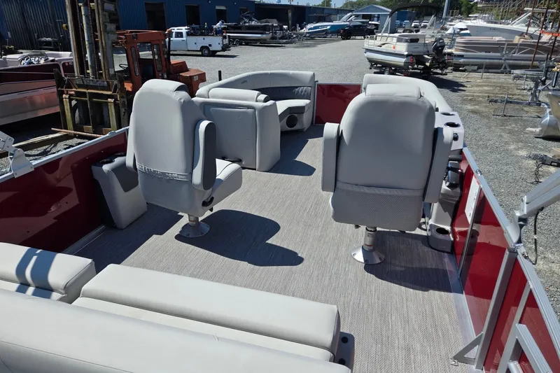 Slide: The Image of 2026 Harris Cruiser 230 pontoon boat interior with gray seating and red accents. - 28