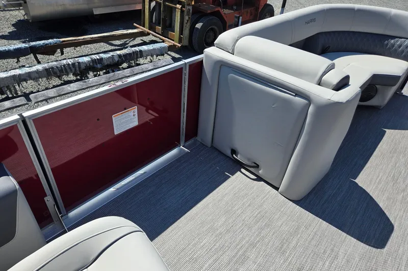 Slide: The Image of 2026 Harris Cruiser 230 interior with gray seating and red paneling. - 32
