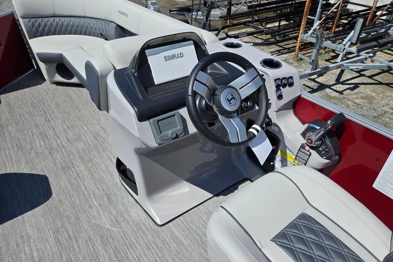 Slide: The Image of 2026 Harris Cruiser 230 boat interior with steering wheel and Simrad display. - 33
