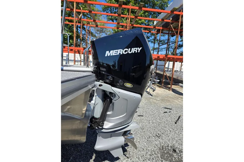 Slide: The Image of 2026 Harris Cruiser 230 with Mercury outboard motor, parked outdoors. - 40