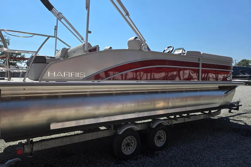 Slide: The Image of 2026 Harris Cruiser 230 pontoon boat on trailer, side view, sunny day. - 6