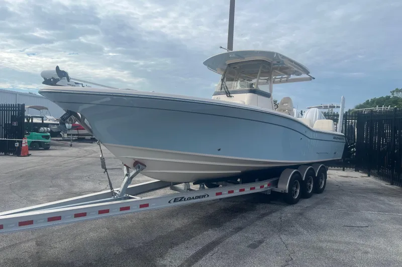 Slide: The Image of 2023 Grady-White 281 Coastal Explorer boat on trailer, parked outdoors. - 2