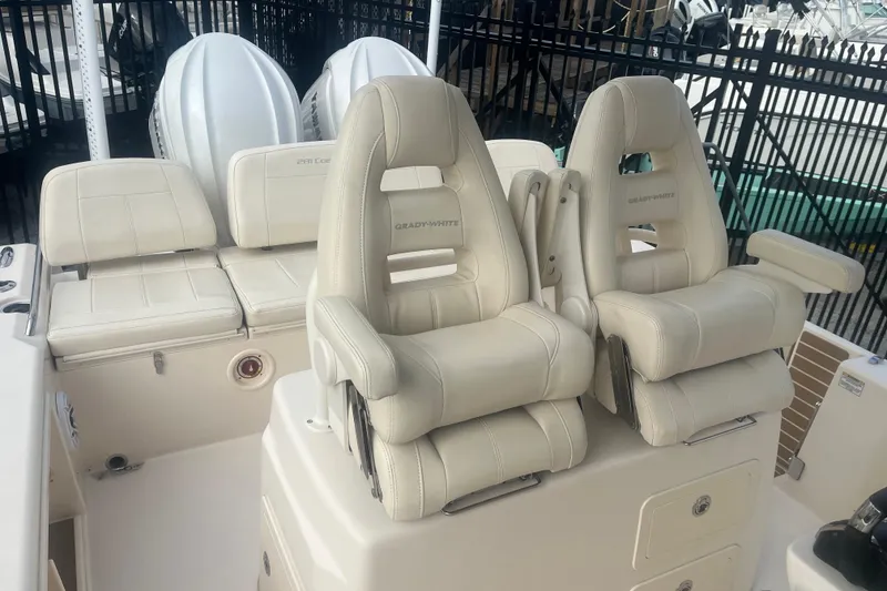 Slide: The Image of 2023 Grady-White 281 Coastal Explorer boat interior with plush seating and helm chairs. - 6