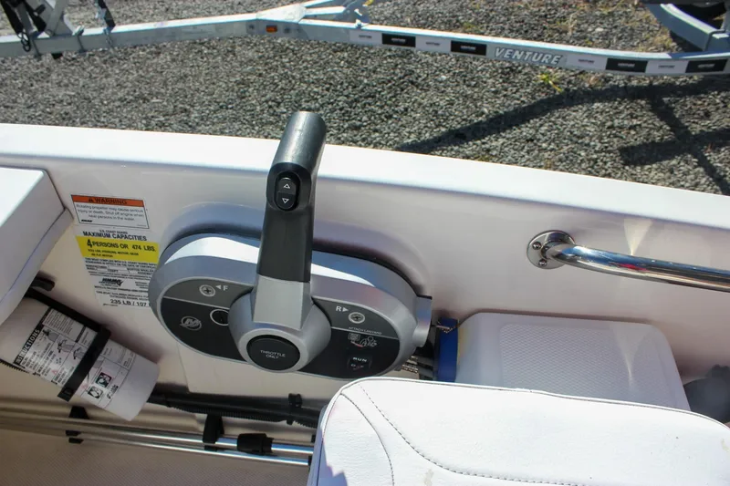 Slide: The Image of 2021 Boston Whaler 130 Super Sport boat controls and seating area. - 13