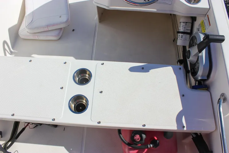 Slide: The Image of 2021 Boston Whaler 130 Super Sport interior with steering controls and seating area. - 14