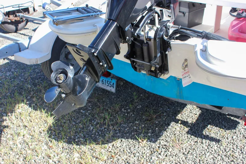 Slide: The Image of 2021 Boston Whaler 130 Super Sport boat engine and propeller detail. - 4