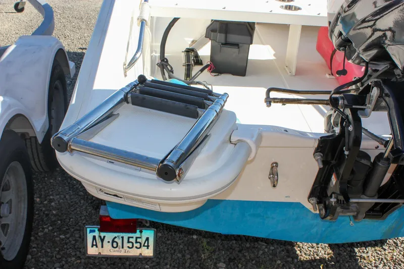 Slide: The Image of 2021 Boston Whaler 130 Super Sport boat with trailer and outboard motor. - 5