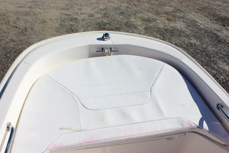 Slide: The Image of 2021 Boston Whaler 130 Super Sport boat interior with white seating and stainless steel railings. - 8