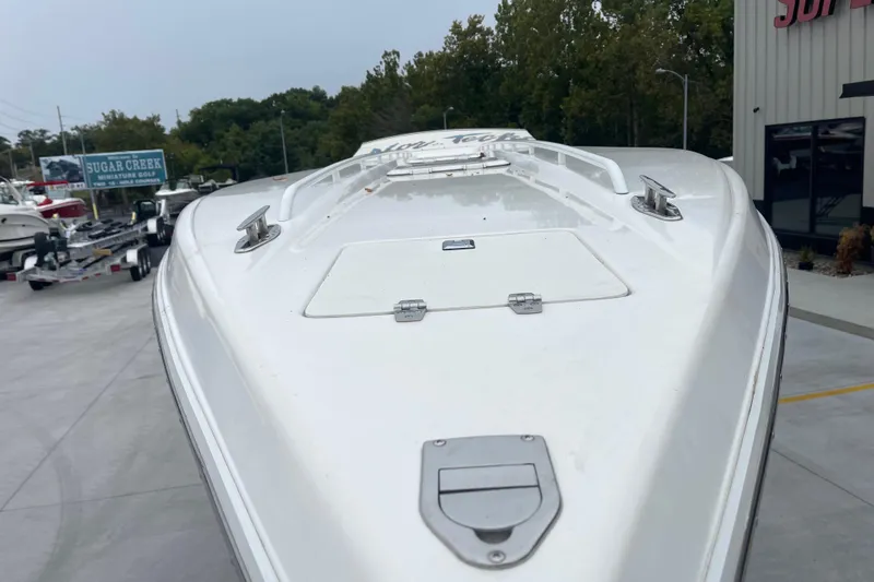 Slide: The Image of 1998 Nor-Tech 5000V Diesel boat, white exterior, parked outdoors near dealership. - 11
