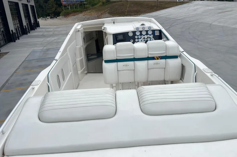 Slide: The Image of 1998 Nor-Tech 5000V Diesel boat interior with white seating and control panel. - 13