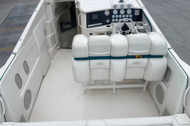Slide: The Image of 1998 Nor-Tech 5000V Diesel boat interior with white seating and control panel. - 14