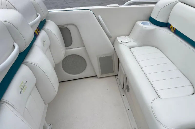 Slide: The Image of 1998 Nor-Tech 5000V Diesel boat interior with white seating and teal accents. - 16