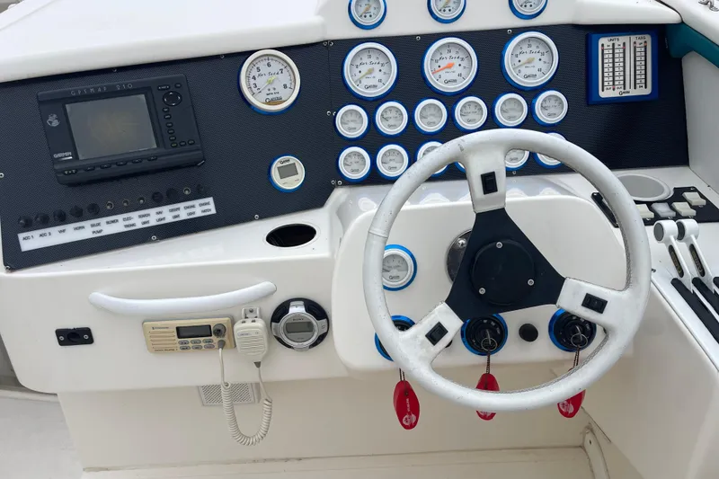 Slide: The Image of Control panel of a 1998 Nor-Tech 5000V Diesel boat with steering wheel and gauges. - 17