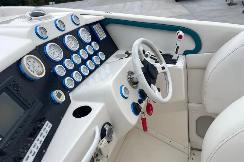 Slide: The Image of Cockpit of 1998 Nor-Tech 5000V Diesel boat with gauges and steering wheel. - 18