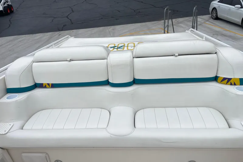 Slide: The Image of 1998 Nor-Tech 5000V Diesel boat with white and teal seating on deck. - 21