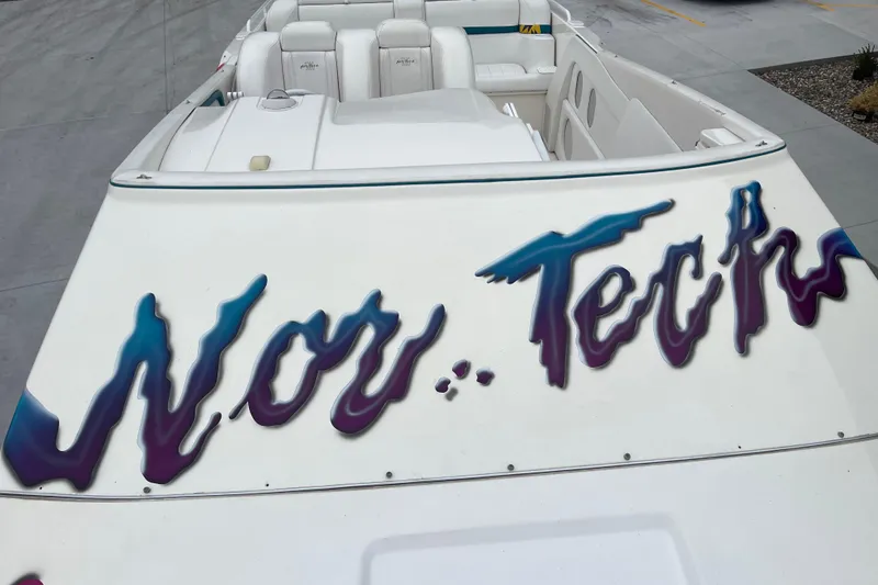 Slide: The Image of 1998 Nor-Tech 5000V Diesel boat with vibrant logo on deck. - 22