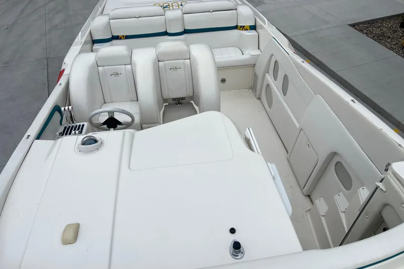 Slide: The Image of 1998 Nor-Tech 5000V Diesel boat interior with white seating and steering wheel. - 23