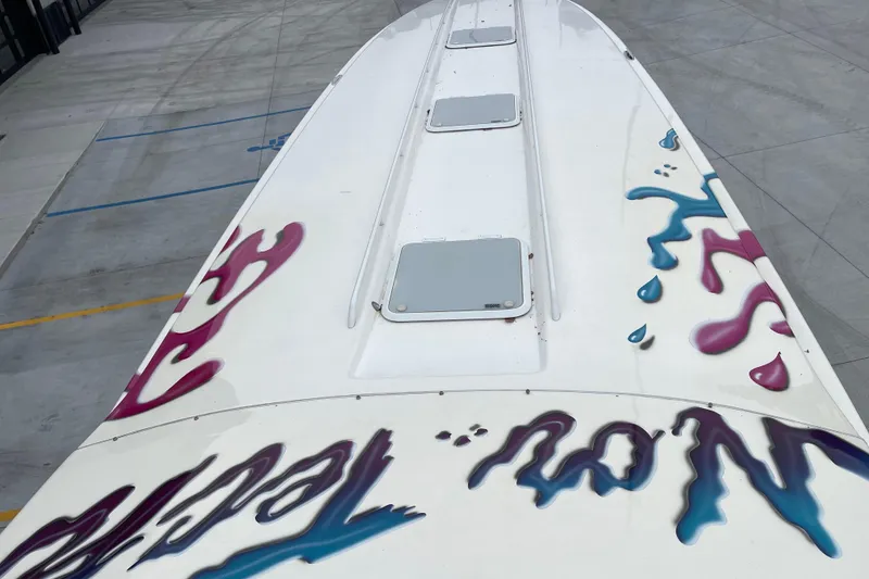 Slide: The Image of Top view of 1998 Nor-Tech 5000V Diesel boat with colorful graphics. - 24