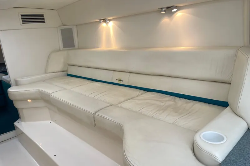 Slide: The Image of Interior of 1998 Nor-Tech 5000V Diesel boat with white leather seating. - 29