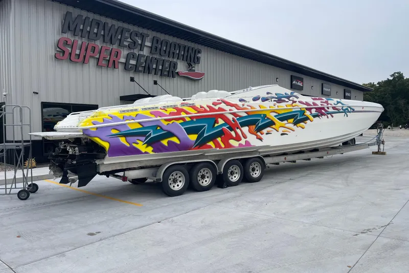 Slide: The Image of 1998 Nor-Tech 5000V Diesel boat with colorful graphics at Midwest Boating Super Center. - 3