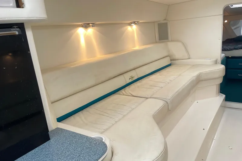 Slide: The Image of Interior of 1998 Nor-Tech 5000V Diesel boat with white leather seating and ambient lighting. - 30