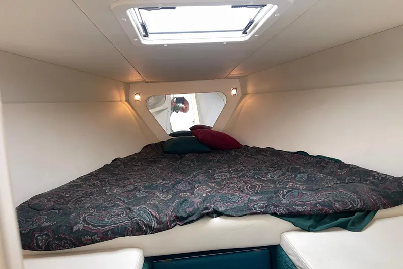 Slide: The Image of Cozy cabin interior of 1998 Nor-Tech 5000V Diesel boat with patterned bedding. - 31