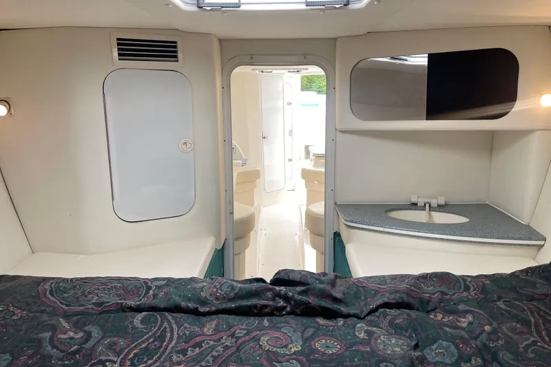 Slide: The Image of Interior of 1998 Nor-Tech 5000V Diesel boat with bed, sink, and seating area. - 32