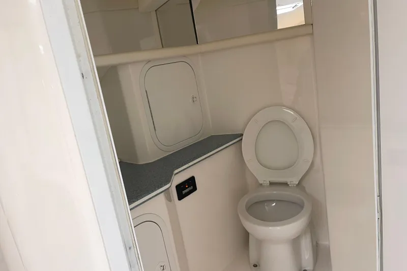Slide: The Image of 1998 Nor-Tech 5000V Diesel boat bathroom interior with toilet and storage compartments. - 33