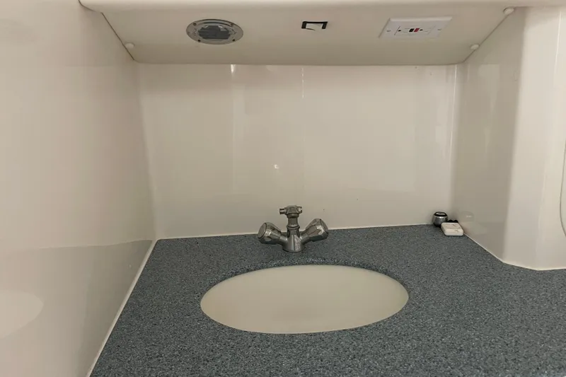Slide: The Image of 1998 Nor-Tech 5000V Diesel boat interior sink with faucet and countertop. - 34