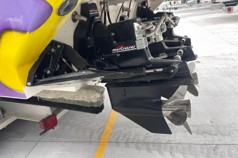 Slide: The Image of 1998 Nor-Tech 5000V Diesel boat with MerCruiser outdrive, featuring vibrant yellow and purple accents. - 5