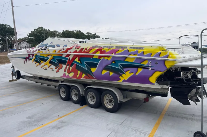 Slide: The Image of Colorful 1998 Nor-Tech 5000V Diesel boat with vibrant graffiti design on a trailer. - 6